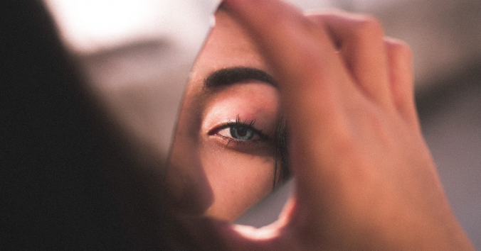 woman looking in mirror, photo by Ismael Sanchez from Pexels