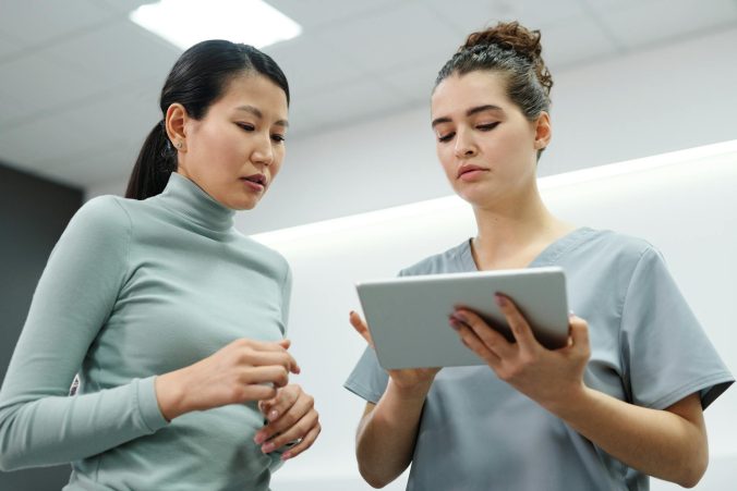 Doctor and patient looking at a tablet.