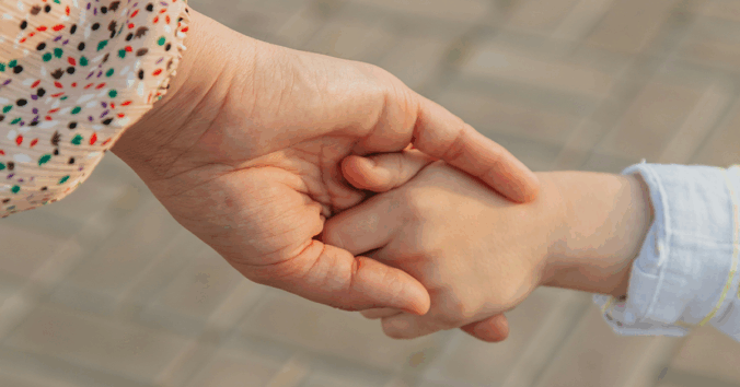Parent and child holding hands